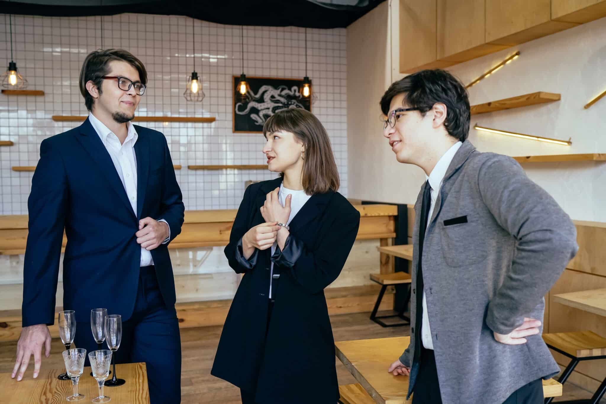 Group of business people in a meeting or briefing standing grouped in a circle having a discussion in a office
